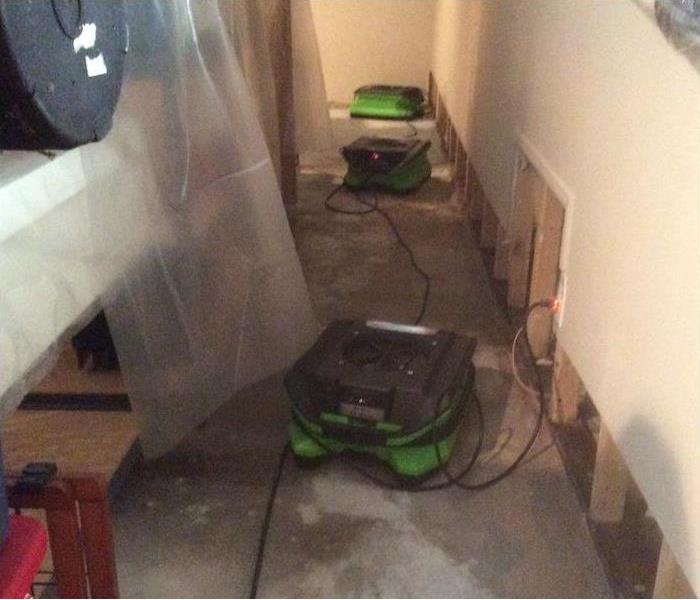 SERVPRO fans set up in a water damaged hallway